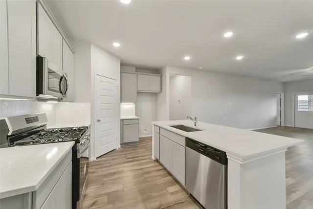 a kitchen that has a sink and a stove in it