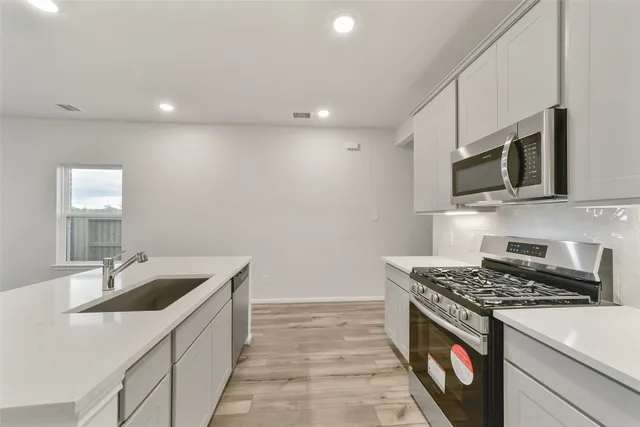 a kitchen that has a sink and a stove