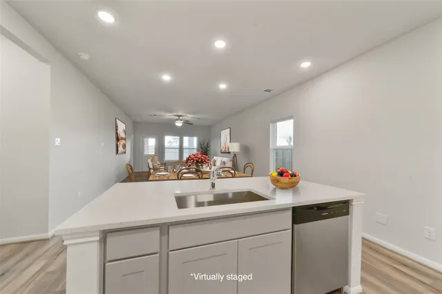 a kitchen with sink and a mirror