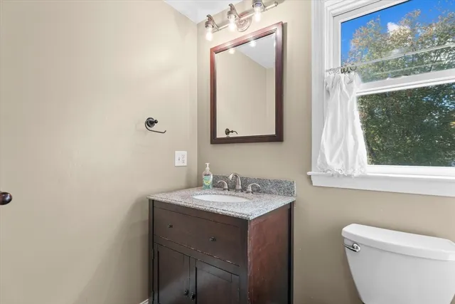 a bathroom with a toilet sink and mirror