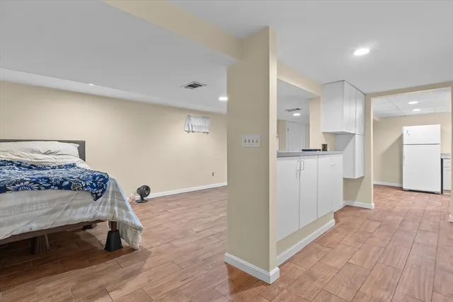 a view of a bedroom with wooden floor