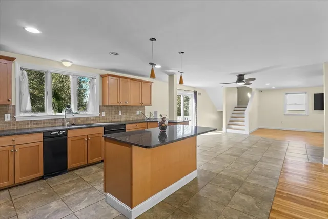 a large kitchen with kitchen island a sink counter space appliances and a window