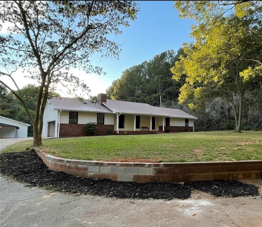 1573 West L Williams Road Commerce, GA 30530 - Photo 1 of 1 a view of a house and a yard