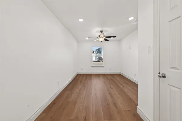 wooden floor in an empty room with a window