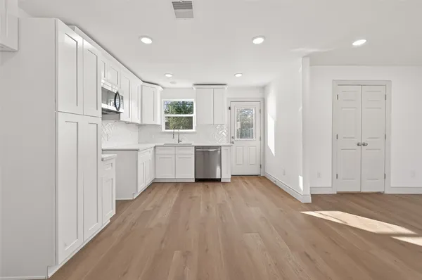 a view of a kitchen with electric appliances