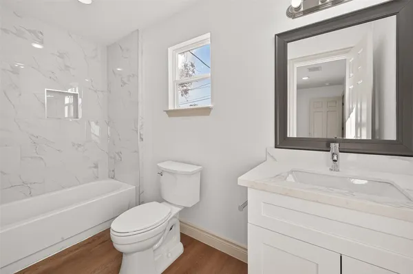 a bathroom with a sink toilet vanity and shower