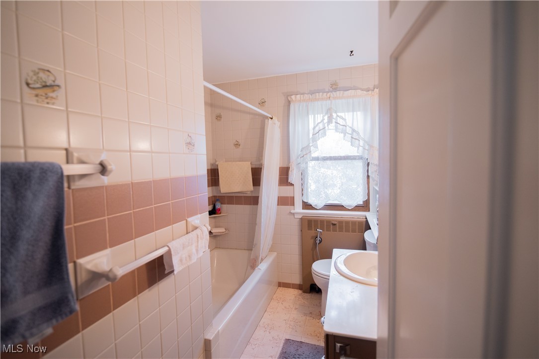 1118 Shields Road Youngstown, OH 44511 - Photo 10 of 21 Full bathroom with tile walls, vanity, toilet, and shower / bath combo
