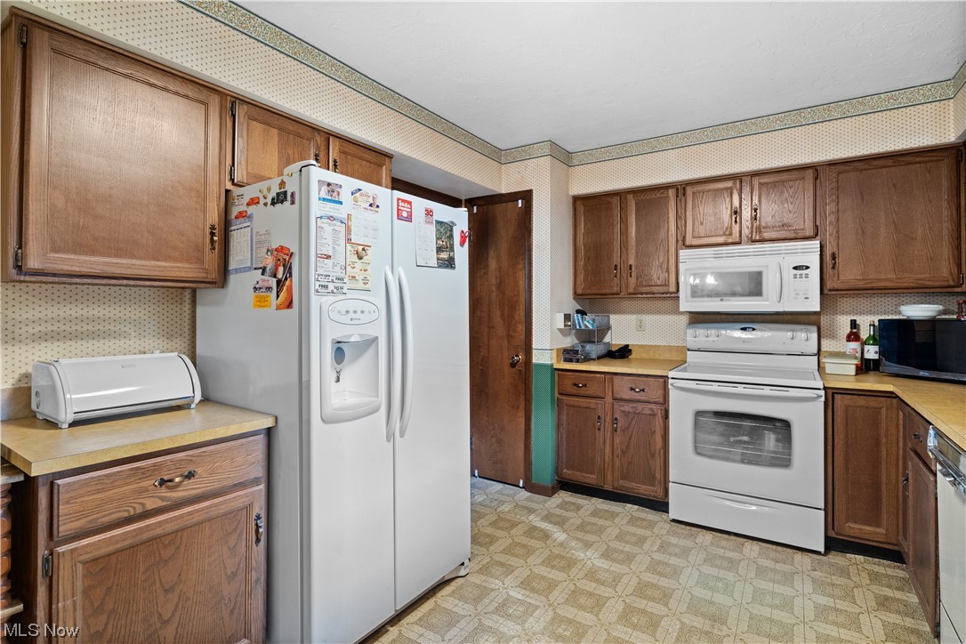 32051 Avon Road Avon, OH 44011 - Photo 10 of 32 Kitchen featuring white appliances and light tile floors