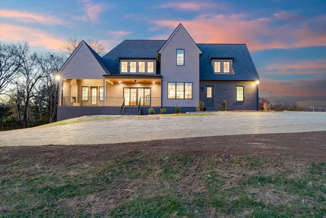 a dining room with furniture a chandelier and window