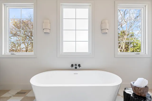 a living room with a fireplace and a floor to ceiling window
