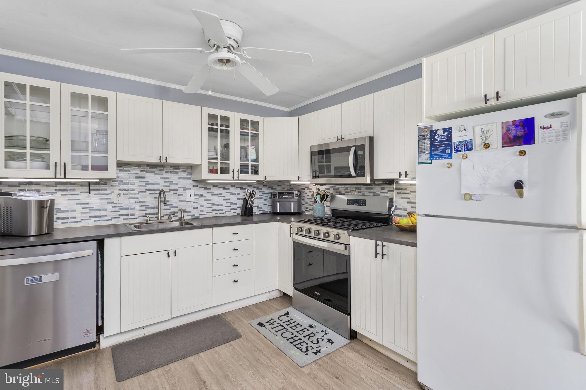 29 West Broadway Maple Shade, NJ 08052 - Photo 14 of 35 a kitchen with granite countertop a sink stainless steel appliances and white cabinets