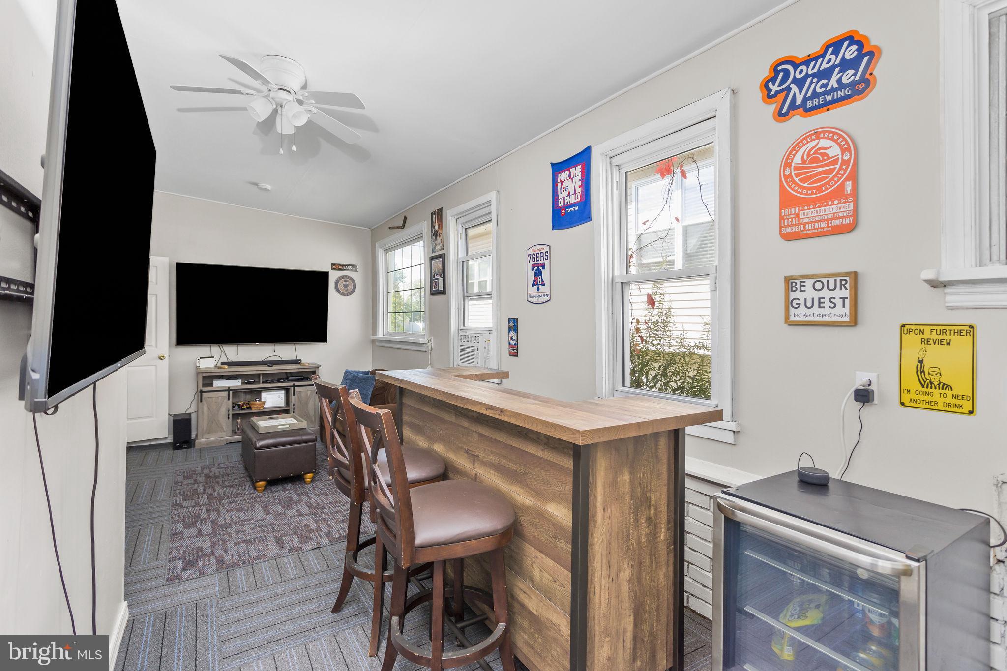 29 West Broadway Maple Shade, NJ 08052 - Photo 19 of 35 a view of a workspace with furniture and a flat screen tv