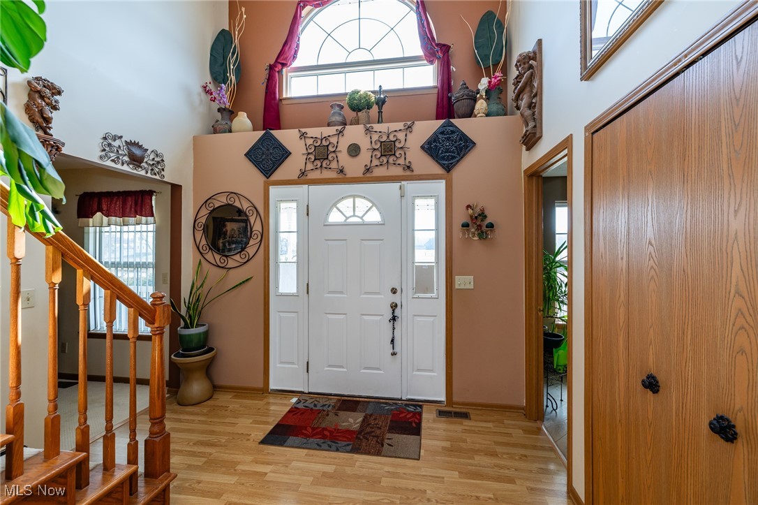12181 Williams Road Homerville, OH 44235 - Photo 3 of 49 Foyer entrance featuring light hardwood / wood-style flooring and a high ceiling