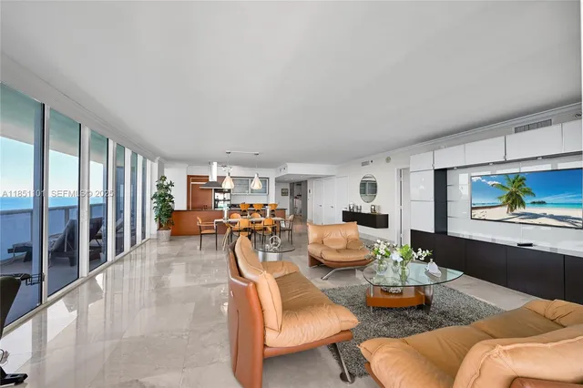 a living room with furniture and a painting on the wall