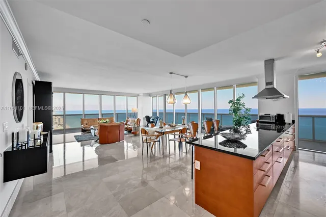 a living room with furniture large window and a fireplace