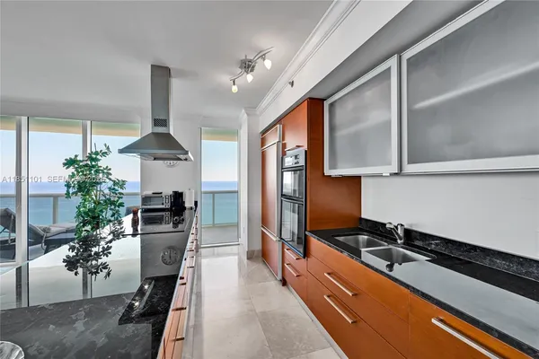 a kitchen with stainless steel appliances a stove refrigerator sink and cabinets