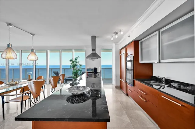 a living room with fireplace furniture and a large window