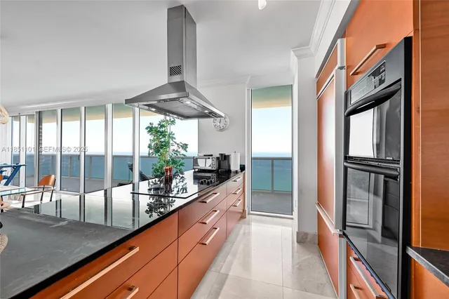 a kitchen with stainless steel appliances granite countertop a refrigerator and a stove