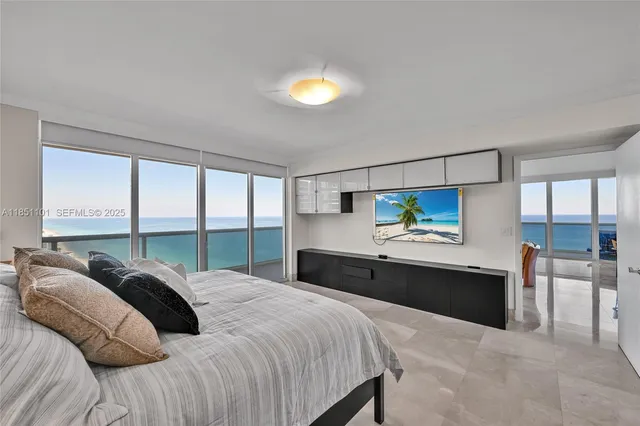 a bedroom with a bed and a large window