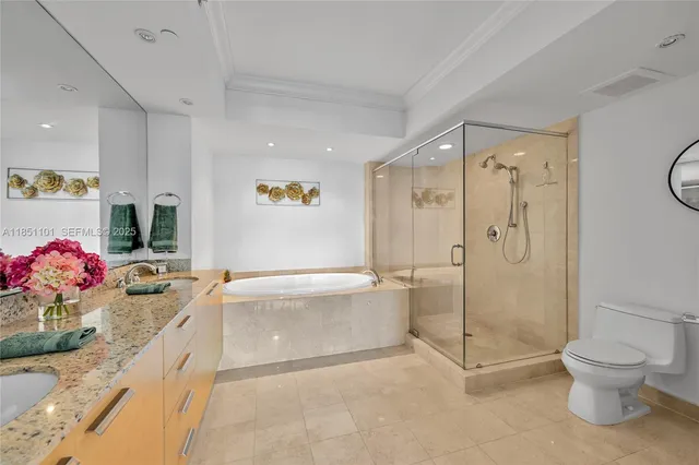 a bathroom with a granite countertop tub sink toilet and mirror