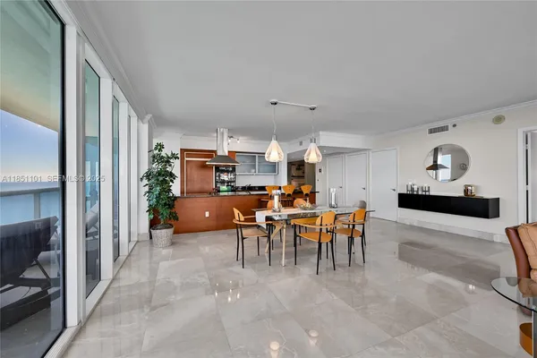 a view of a dining room with furniture and chandelier