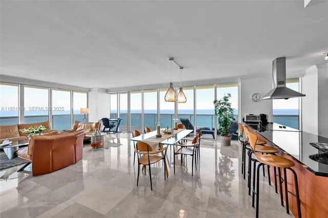 a room with lots of tables a large window and furniture