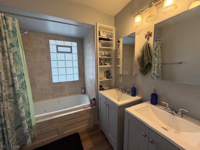 35180 Solon Road Solon, OH 44139 - Photo 18 of 33 Full bathroom featuring two vanities, a combined bath / shower with jetted tub, and dark wood-style flooring