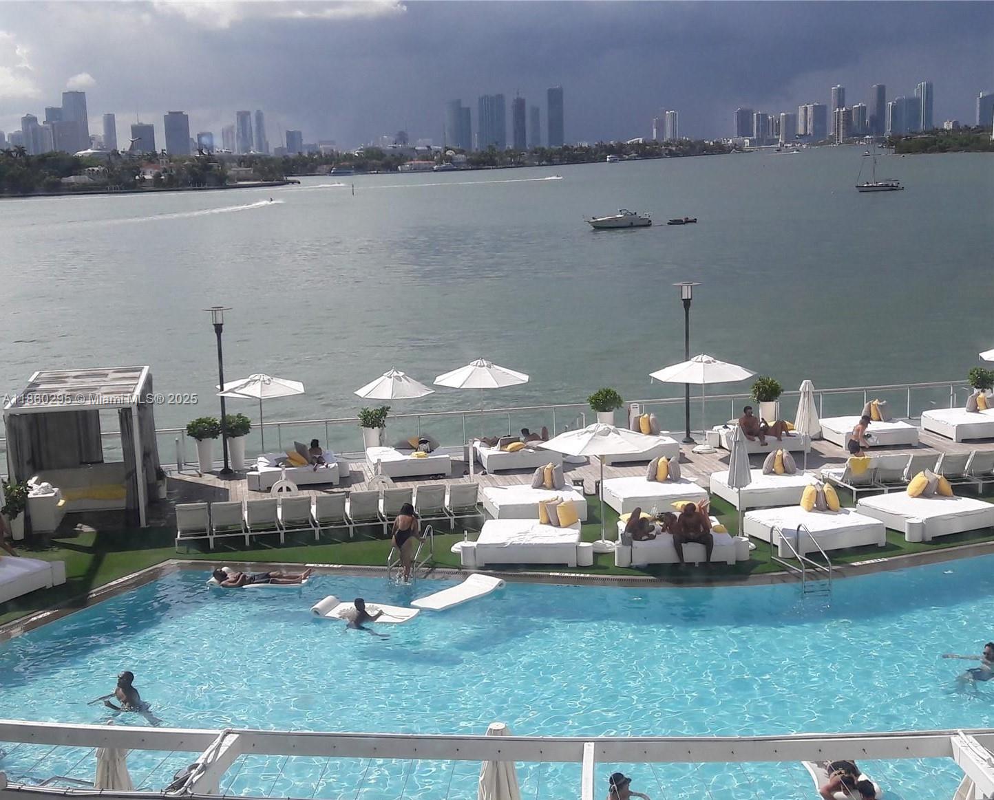 1100 West Avenue, Unit 1402 Miami Beach, FL 33139 - Photo 44 of 58 a lots of white furniture and a table in a lake