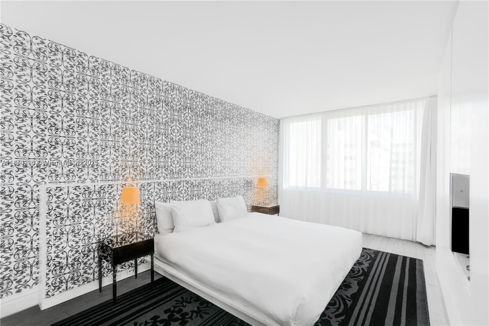 1100 West Avenue, Unit 1402 Miami Beach, FL 33139 - Photo 6 of 58 a bedroom with a bed and a window