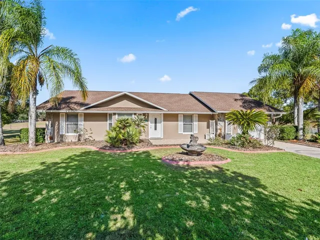 a front view of house with yard and outdoor seating