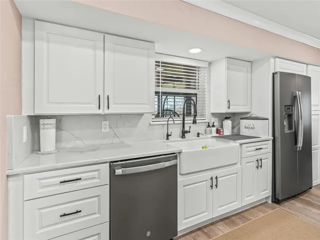 a kitchen with appliances cabinets and a sink