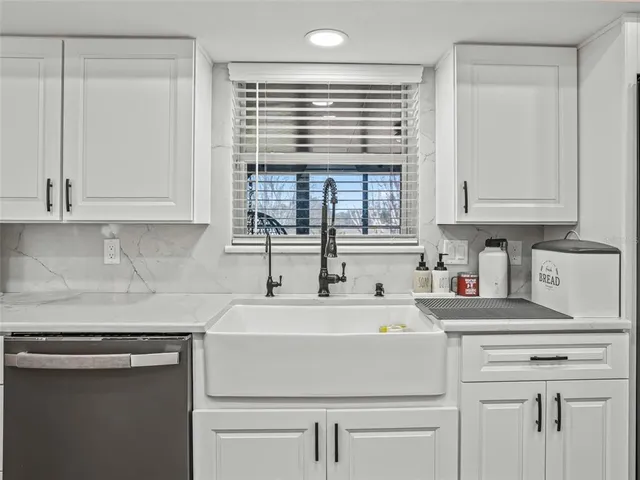 a kitchen with a sink cabinets and window
