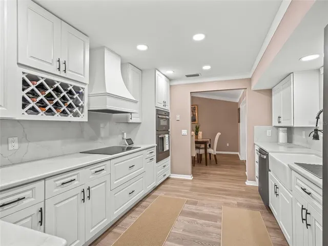 a kitchen with cabinets a sink and appliances
