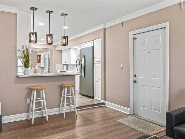 a view of kitchen with refrigerator and window