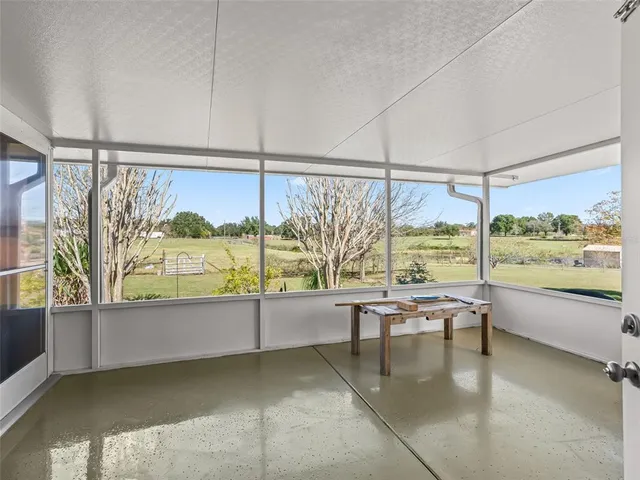 a view of a living room and floor to ceiling window or dining room