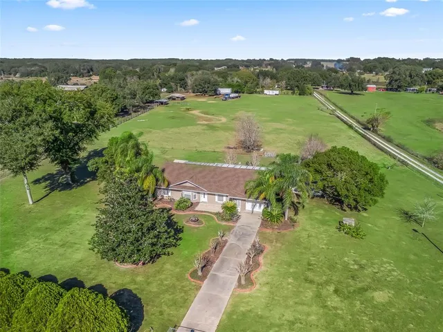 an aerial view of a houses with outdoor space and a lake view