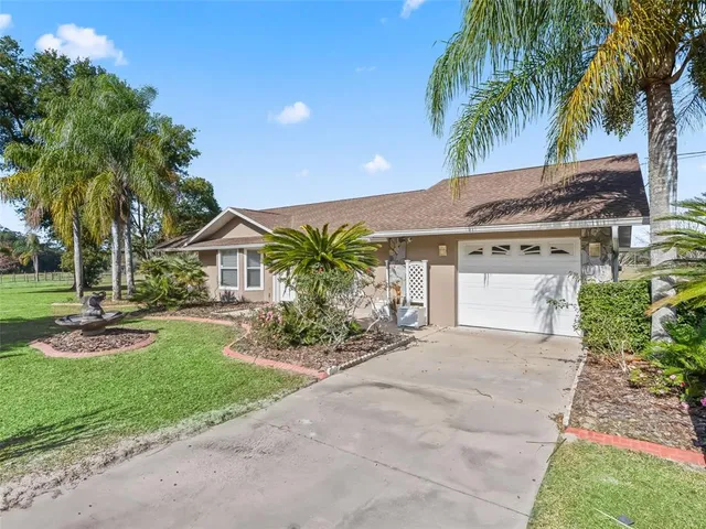 a front view of house with yard and green space