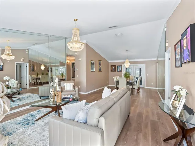 a living room with furniture a chandelier and a chandelier