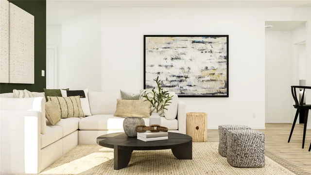 a living room with furniture and a painting on the wall