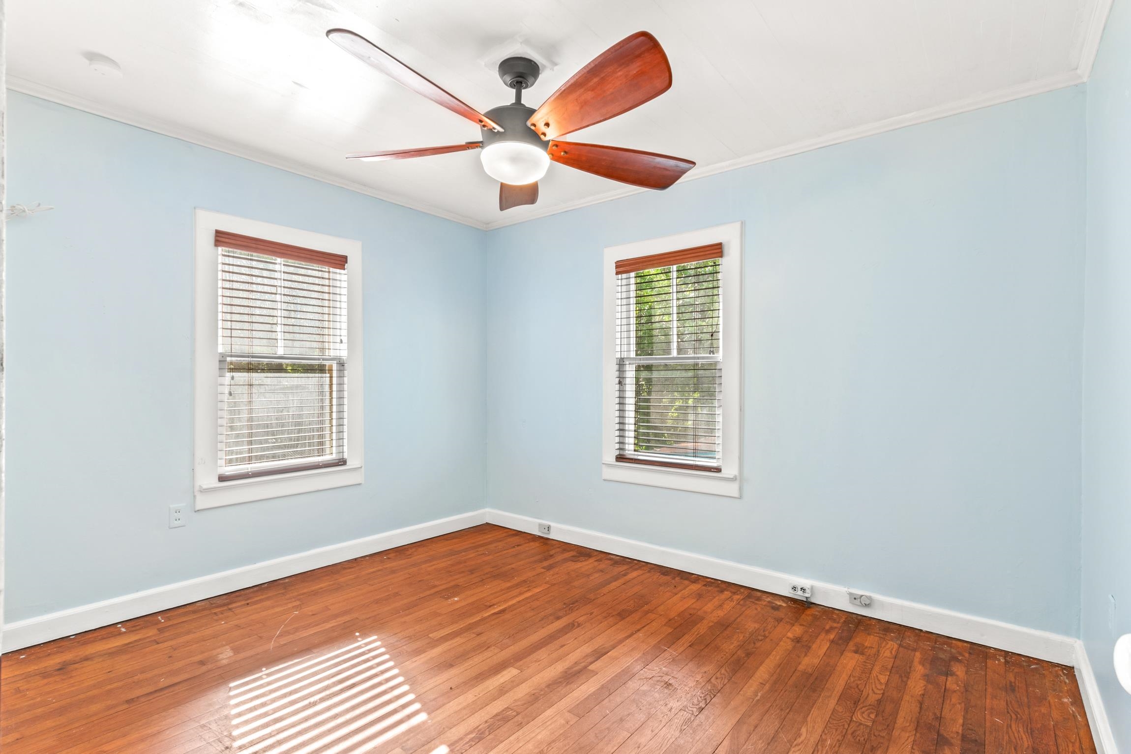 26 Ponce De Leon Avenue St. Augustine, FL 32080 - Photo 12 of 51 an empty room with wooden floor ceiling fan and windows
