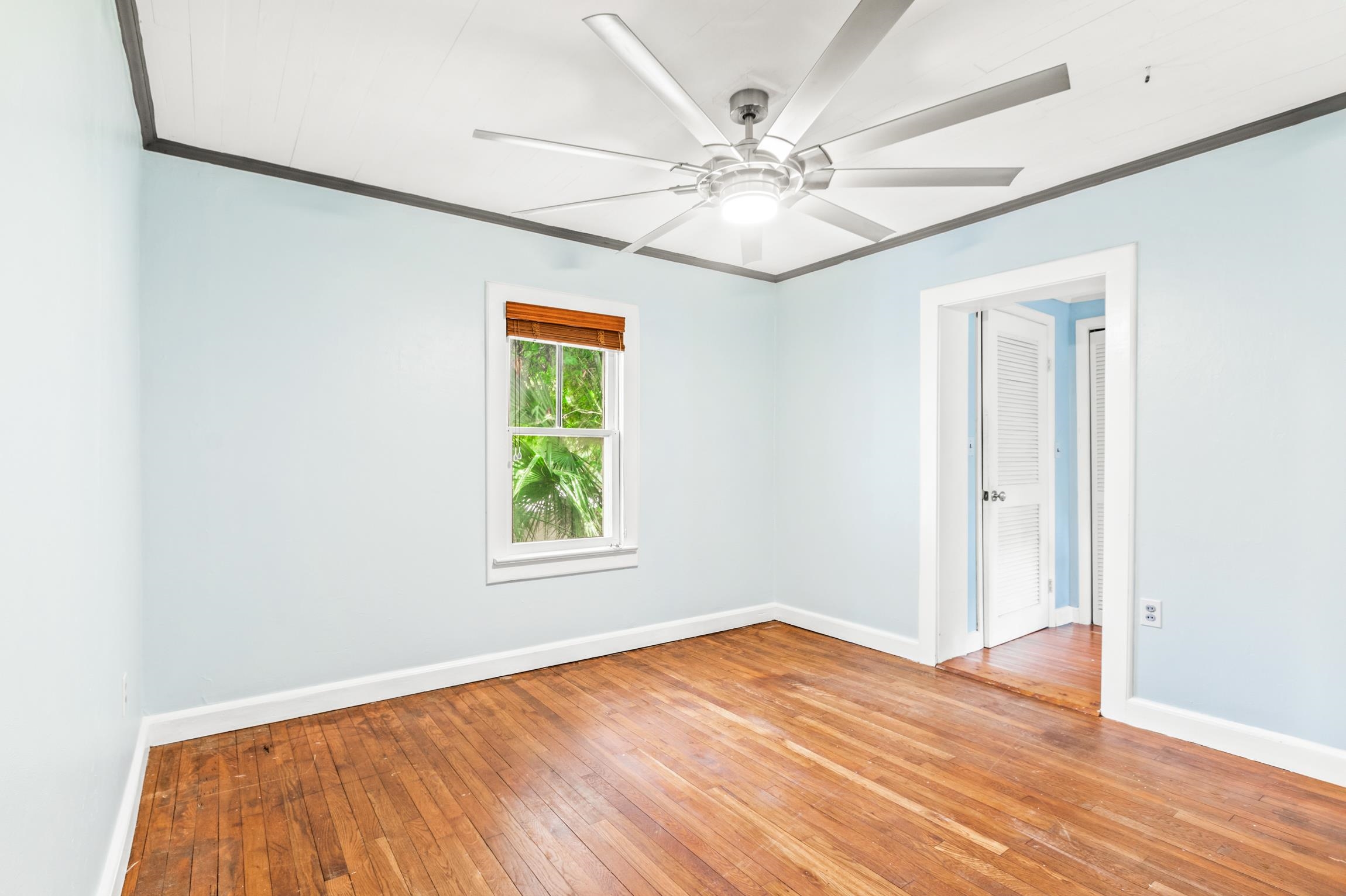 26 Ponce De Leon Avenue St. Augustine, FL 32080 - Photo 17 of 51 an empty room with wooden floor fan and windows