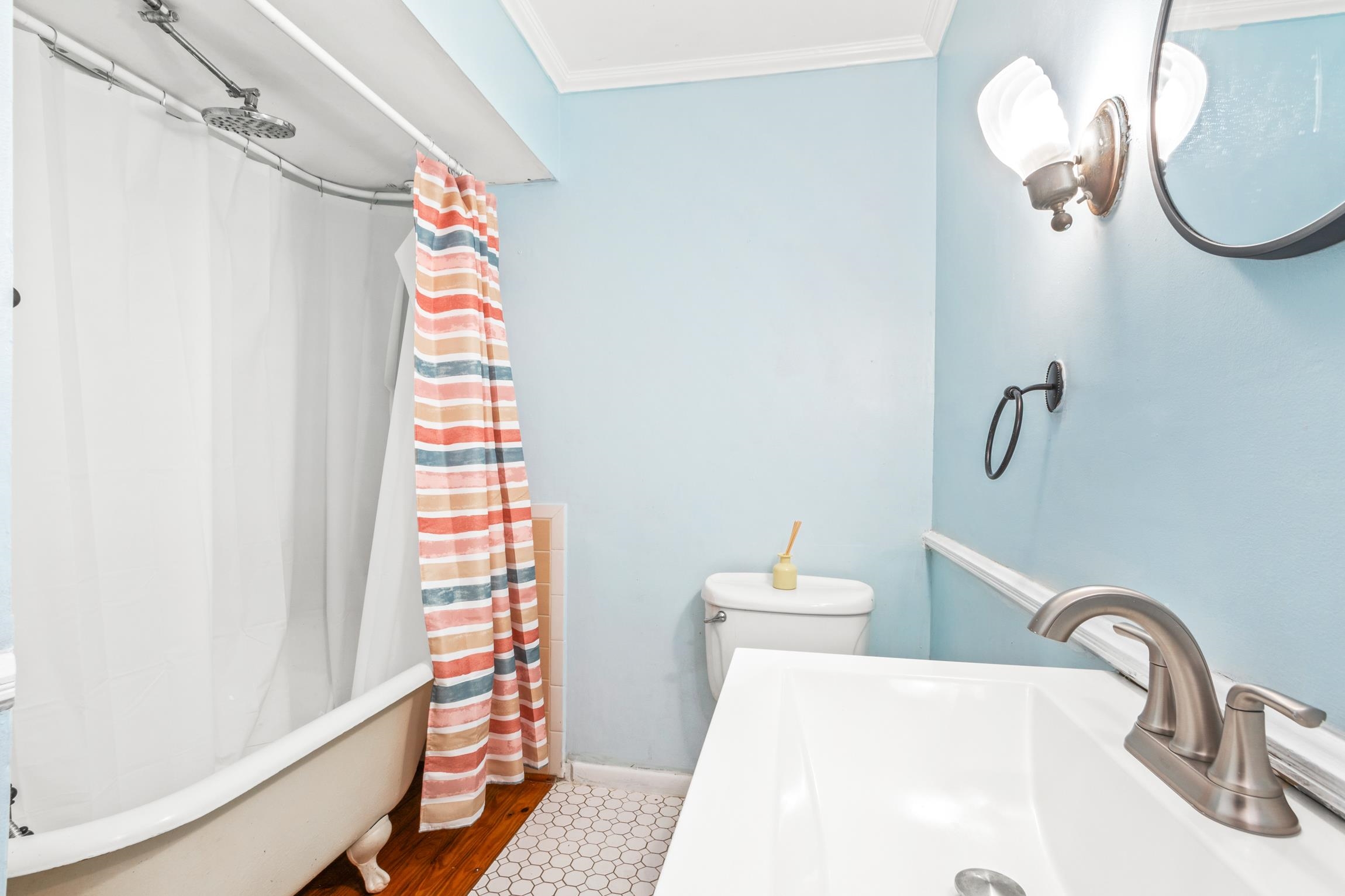 26 Ponce De Leon Avenue St. Augustine, FL 32080 - Photo 18 of 51 a bathroom with a sink a toilet and shower curtain