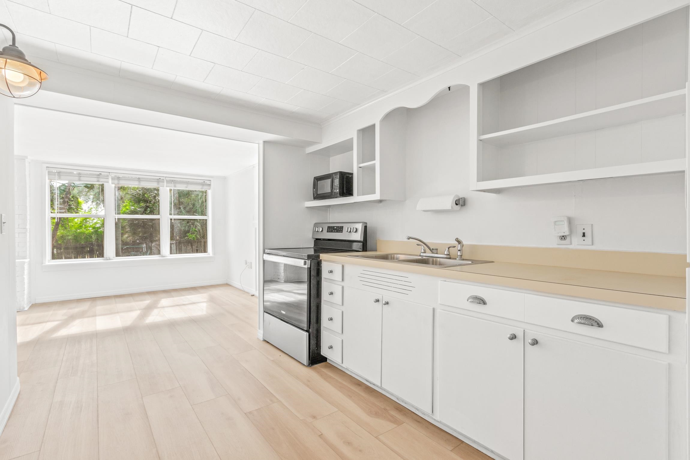 26 Ponce De Leon Avenue St. Augustine, FL 32080 - Photo 22 of 51 a kitchen with granite countertop a stove a sink and a microwave