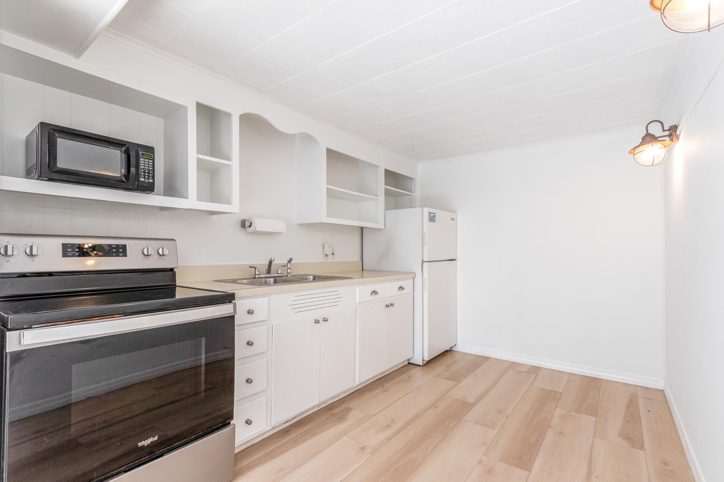 26 Ponce De Leon Avenue St. Augustine, FL 32080 - Photo 23 of 51 a kitchen with granite countertop white cabinets and white appliances