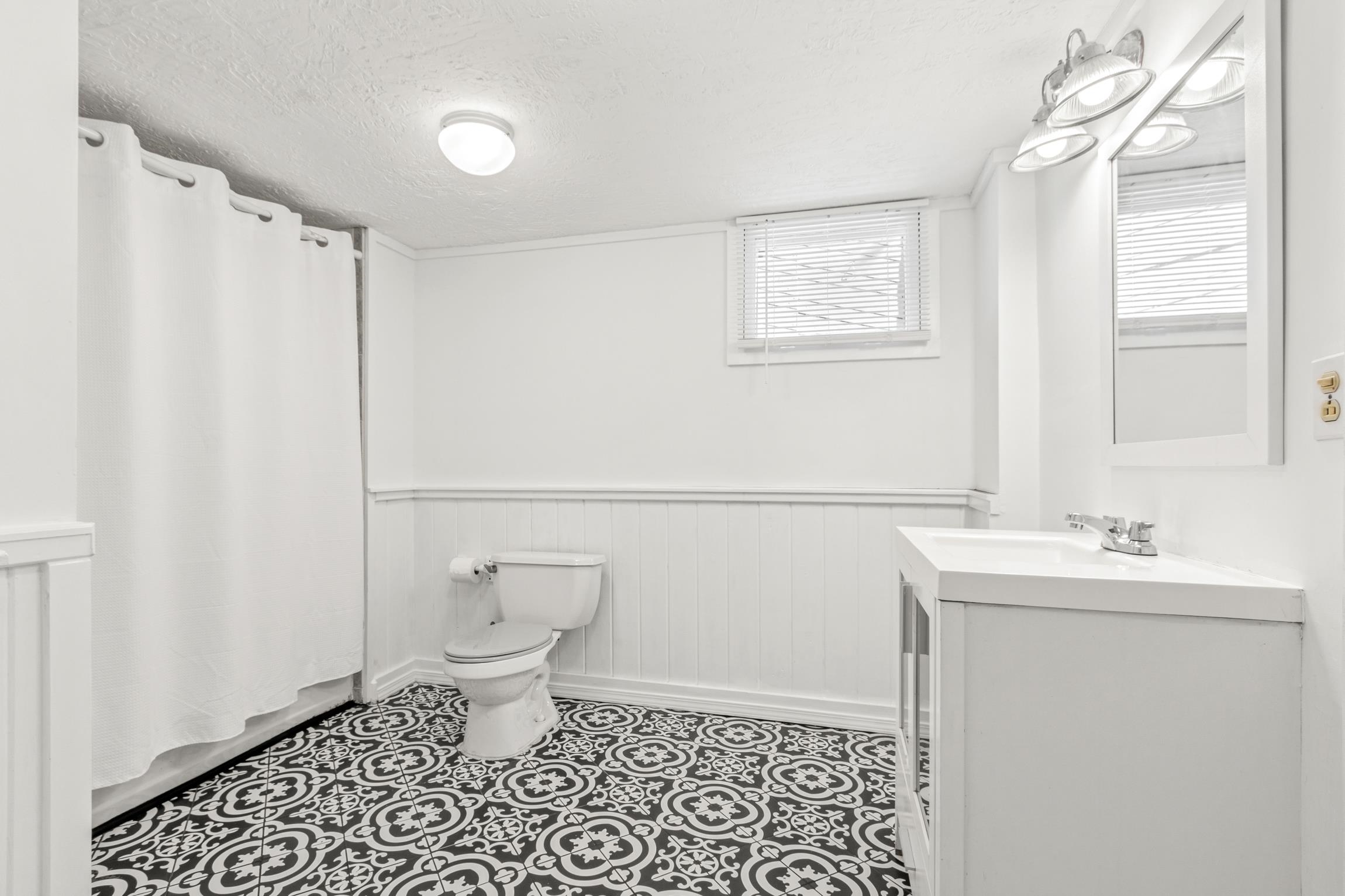 26 Ponce De Leon Avenue St. Augustine, FL 32080 - Photo 31 of 51 a bathroom with a sink a toilet and a shower