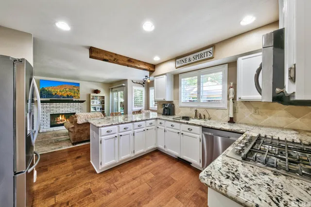a kitchen with stainless steel appliances granite countertop a stove and a sink