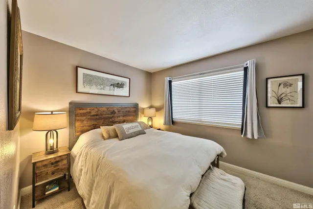 a bedroom with a bed and a night stand