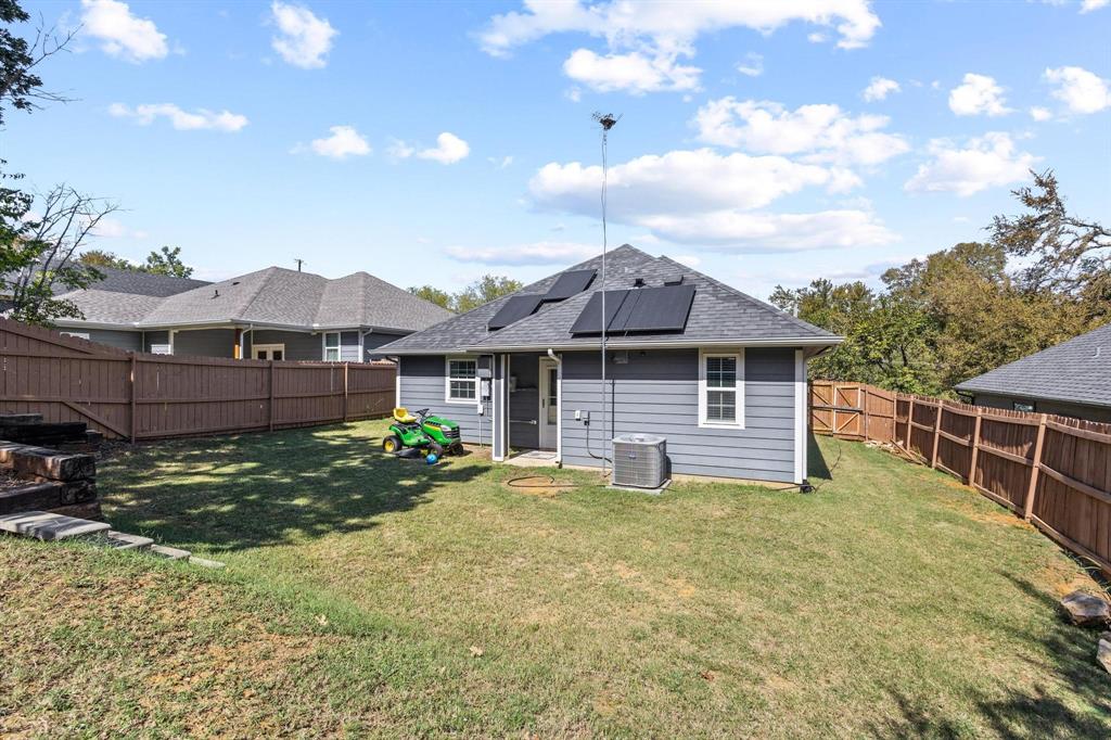 608 East Shepherd Street Denison, TX 75021 - Photo 27 of 31 Fenced backyard with a sloped lawn and mature trees