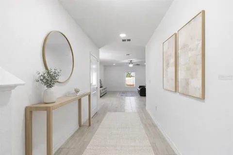a view of a bathroom with mirror and window
