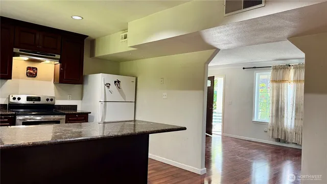 a kitchen with stainless steel appliances a refrigerator and a stove top oven